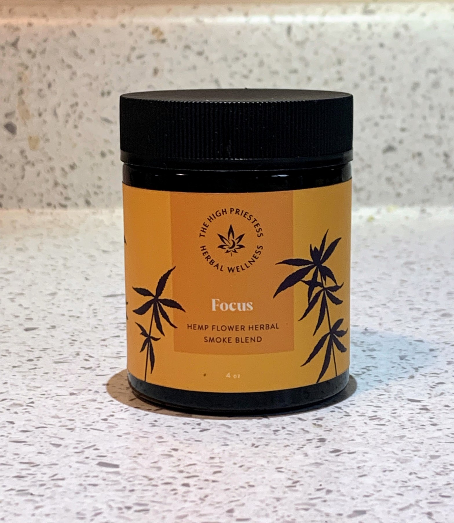 high priestess herbal wellness focus blend container sits on white countertop