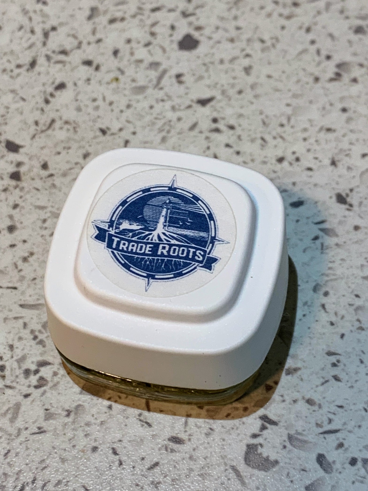 Trade Roots concentrates container on white countertop